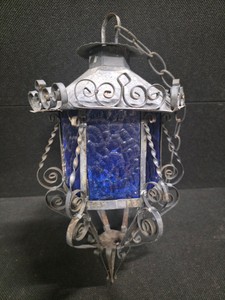 Vintage Hanging Lantern featuring a Decorative Wrought Iron Frame and Textured Blue-Glass Panels