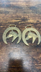 2 brass racing horse themed medallions