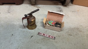 Vintage collectibles Fulton torch, Ford Galaxy metal emblem, and baby champion boat