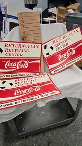 Lot of Coca Cola Recycling Advertising Signs