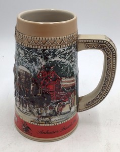 Ceramic stein featuring Budweiser Clydesdales wagon parade scene at Grants Farm gates. Base marked handcrafted expressly for Anheuser-Busch C Series with winter parade description. Classic promotional beer stein design with sturdy ceramic form.