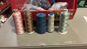 Bucket of miscellaneous serger threads