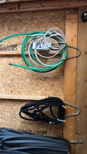 lots of garden hoses and Wall hangers