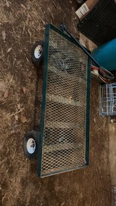 three wheelbarrows and one rolling cart