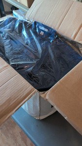 box of button-up cotton shirts