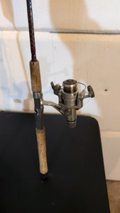 two fishing poles one still has a tag