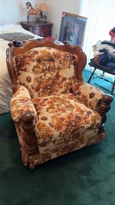 two wooden chairs with design