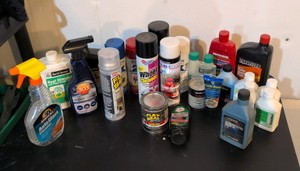 hodgepodge of oil and other random liquids in a green bucket