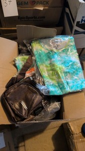 box of shoulder bags and tie-dye t-shirts