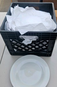 crate of white dishes