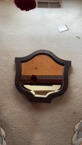 Vintage wood framed, shieldship-crest shaped mirror