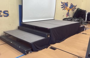 Stage with 2 sets of stairs and skirting (gym)