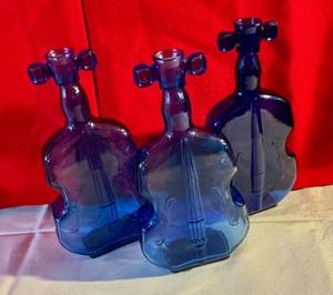 Collectable group of cello shaped cobalt blue glass bottles