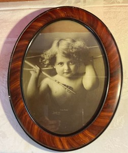 Vintage cupid awake lithograph by M. V. Parkinson in oval frame