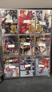 A collectors album full of hockey cards, inserts, rookies, and Hall of Famers