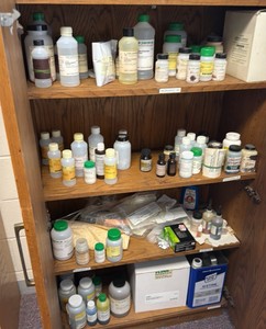 cabinet full of various solutions for science projects