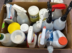 box of cleaning supplies, mostly half bottles