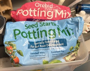 Bucket of potting mix, seed starters and miscellaneous