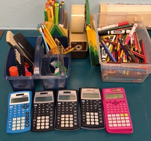 lot of calculators, colored pencils, pens, pencil sharpener and markers