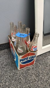 assorted vintage Pepsi bottles