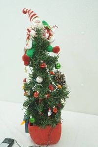 festive Christmas tree with flashing lights and Santa on top