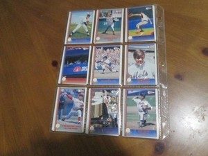 Double sided page of baseball cards including an assortment of years and players