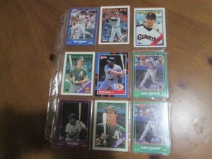 Double sided page of sports cards including Cal Ripken, Wade Boggs, Mark McGuire, Darryl Strawberry, Jose Canseco and others
