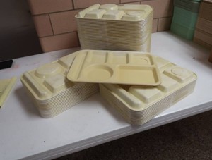 STACK OF EDWARD DON AND CO YELLOW LUNCH TRAYS
