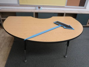 LARGE KIDNEY SHAPED TABLE WITH SMALLER ARROW SIGN