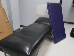 MEDICALNURSES OFFICE BED AND BLUE PADDED ROOM DIVIDER