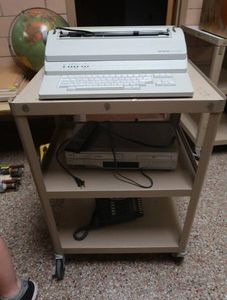 METAL ROLLY CART WITH TYPER, PHONE AND DVDVHS PLAYER