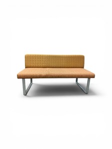 Esto soft seating bench features a unique two-tone design with a patterned yellow back and an orange seat Retails for $1200