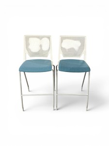 bar stools feature perforated white backs and sky blue upholstered seats
