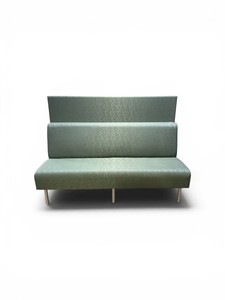 The Global Venture banquette bench features a distinctive green patterned fabric and sits on silver metal legs