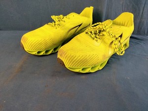 These fluorescent yellow running sneakers feature a distinct blade-style cushioned sole and breathable mesh upper. Size 13