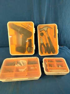 Collection of household hand tools, a cordless drill, and various wall anchors, screws, and nails organized