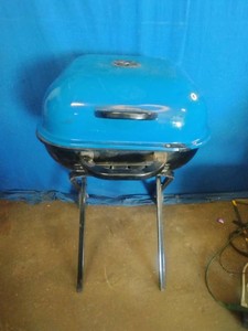 Americana Walk-A-Bout portable charcoal grill in blue.