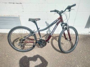 Maroon Specialized Hotrock 24 mountain bike with 24-inch wheels.