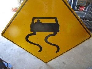 Decomm. Slippery Road Sign
