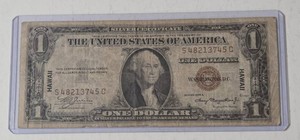 1935A $1 Silver Certificate featuring a Hawaii overprint, which was issued as emergency currency during WWII.  This is a brown note.