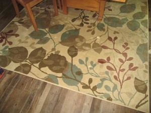 Neutral tone leaf print area rug ap...