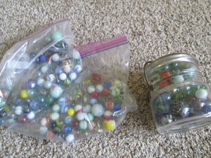 Lidded jar and bag of vintage marbl...