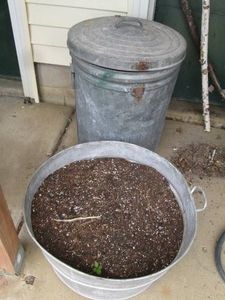 Metal lidded trash can and garden p...