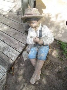 Cement fishing boy lawn ornament as...