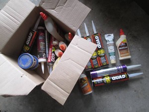 Box of various wood glues, filler, ...