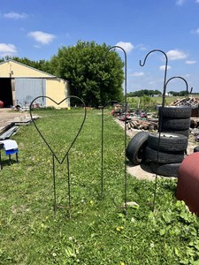 Large metal heart-shaped garden stake and three shepherds hook garden stakes.
