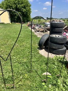 Large metal heart-shaped garden stake and three shepherd's hook garden stakes.