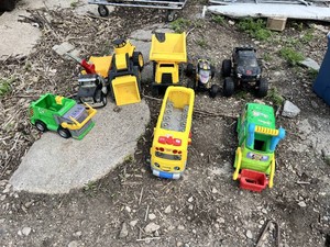 Toy vehicles including trucks, school bus, and toy dump trucks
