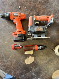 Black and Decker Power Tool Lot including 12V Cordless Drill, Jigsaw Body, Battery-Powered Screwdriver and AA Battery Holder - Unteseted