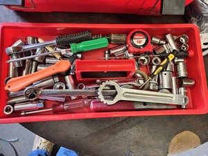 Red Plastic Toolbox with Stanley and Husky Sockets, Screwdrivers, Wrenches, Tape Measure, Rope and Assorted Hardware